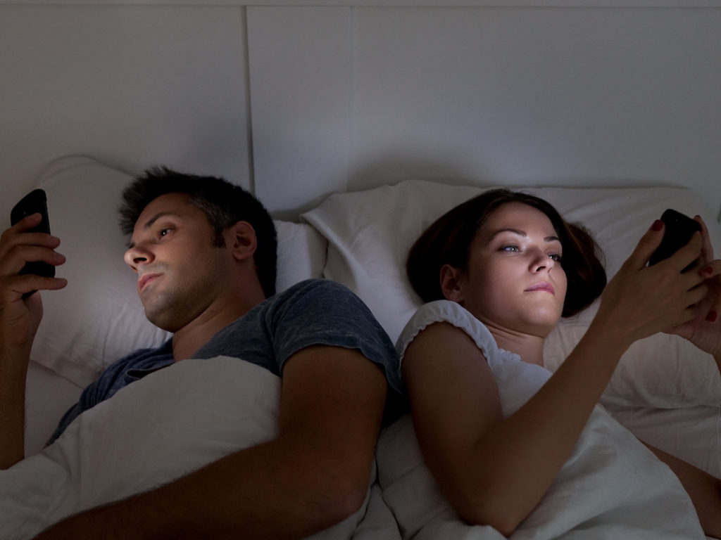 Are You Using Your Phone in Bed? Find Out the Risks.