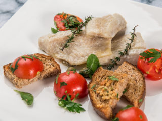 cod fillet with garlic bread and cherry tomatoes