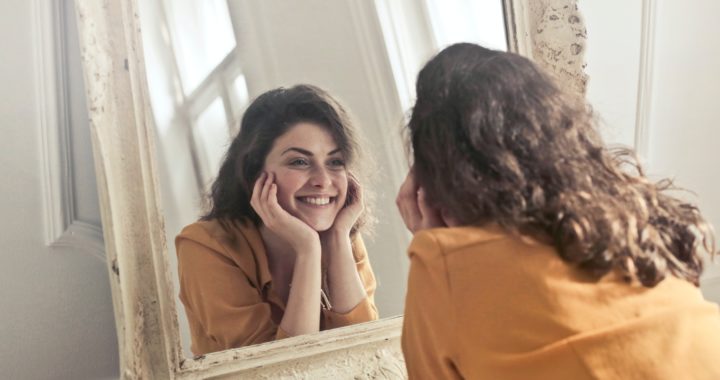 Woman smiling in her mirror